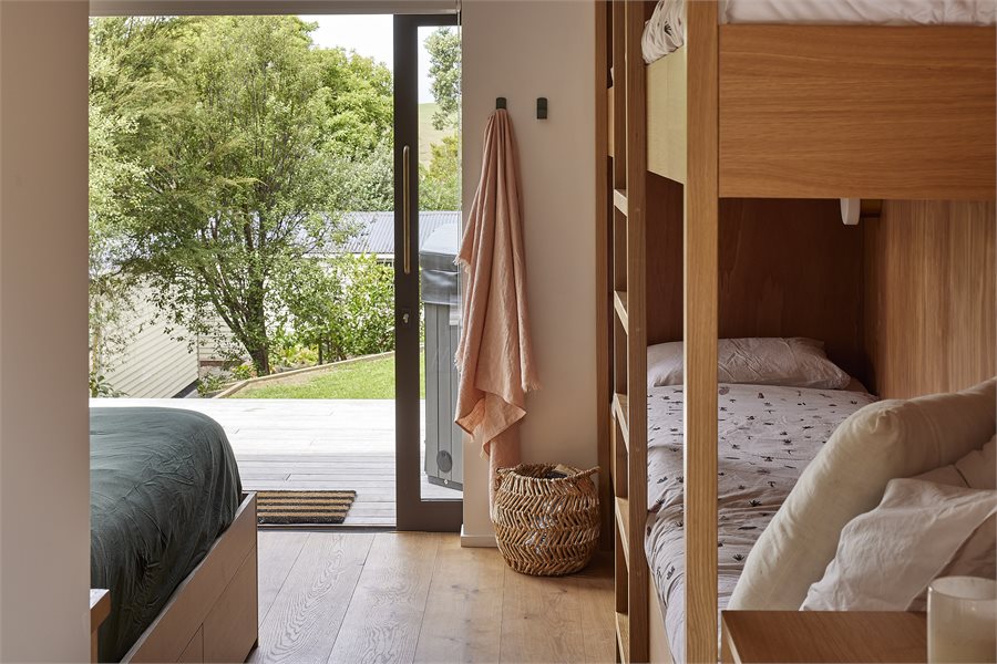 The guest box features custom-built bunk beds. The Vantage sliding door opens to the spa and lawn.