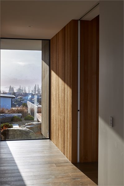 In the hallway, the family never tire of looking out the full-height Vantage picture window, perfectly framing Ruby Island.